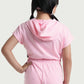 Back view of pink girls hooded romper with elastic waistband